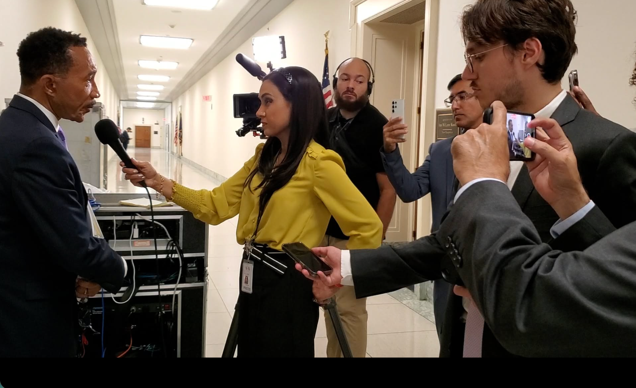 Reporter conducting an interview in a congressional hallway